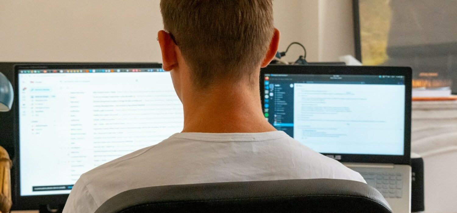 a man sitting in front of a computer