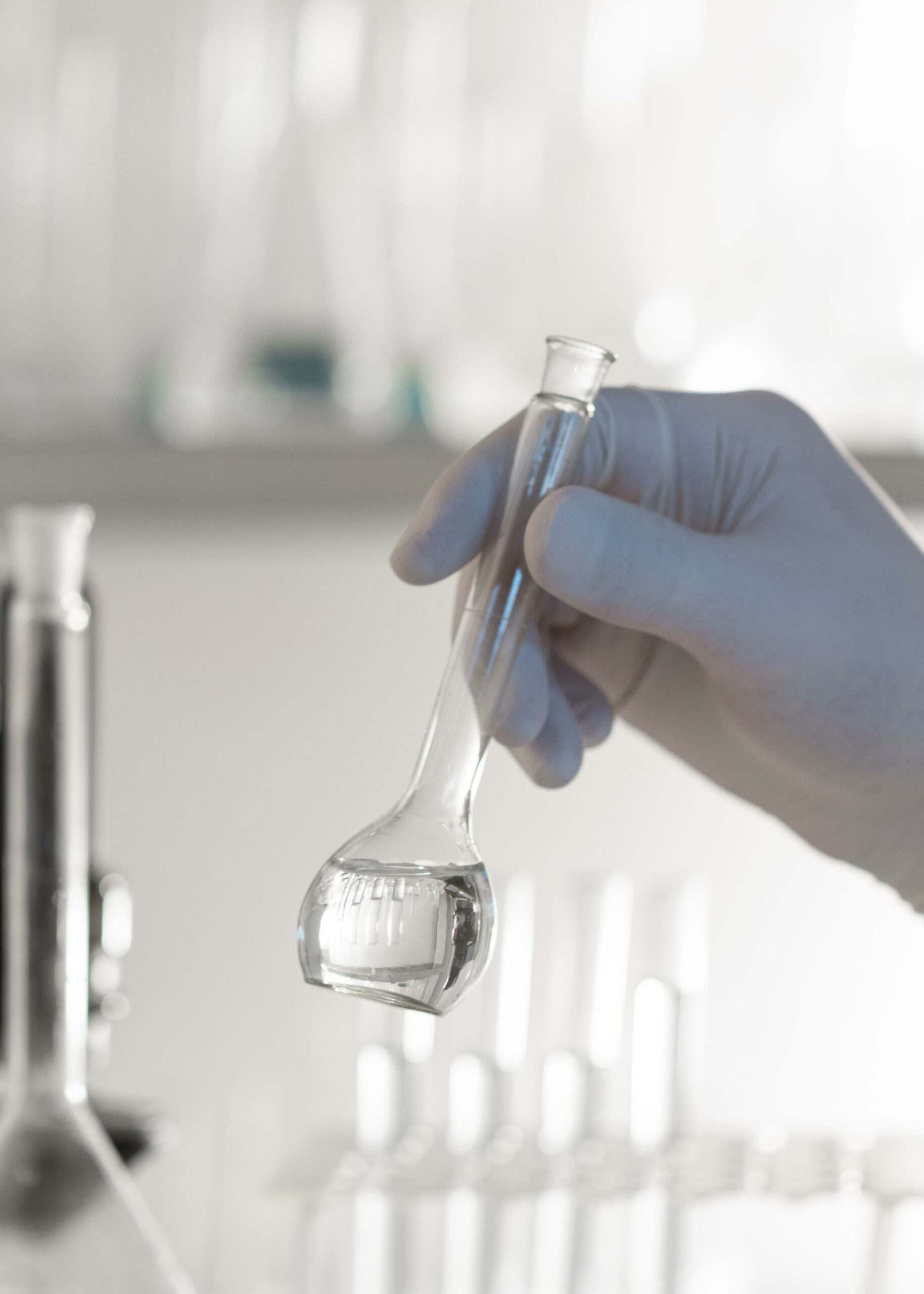 close-up-hand-holding-lab-glassware